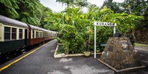 Kuranda railway station with train and signpost